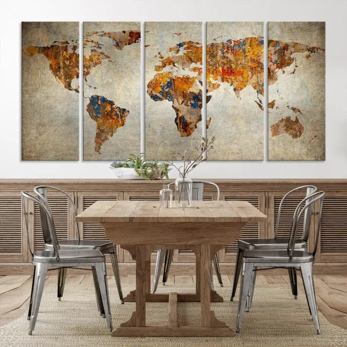 A triptych of Watercolor World Map Canvas Wall Art Prints is displayed in a dimly lit room.