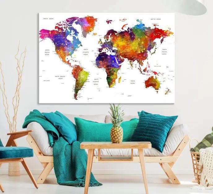 In this stylish living room, a vibrant Watercolor World Map Push Pin Poster Print, enhanced with a satin varnish for extra elegance, is displayed prominently.