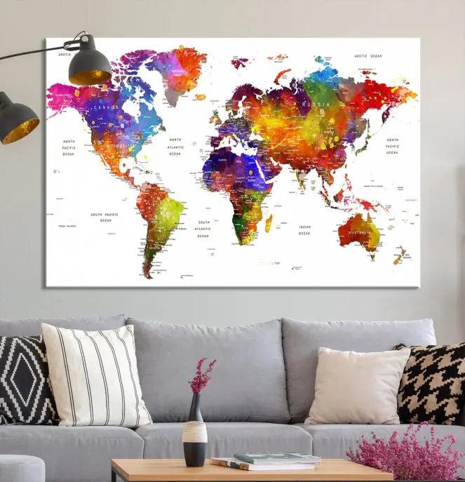 In this stylish living room, a vibrant Watercolor World Map Push Pin Poster Print, enhanced with a satin varnish for extra elegance, is displayed prominently.