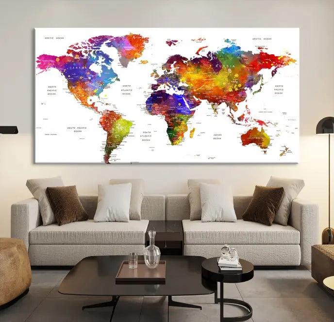 In this stylish living room, a vibrant Watercolor World Map Push Pin Poster Print, enhanced with a satin varnish for extra elegance, is displayed prominently.