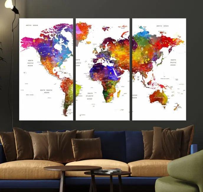 In this stylish living room, a vibrant Watercolor World Map Push Pin Poster Print, enhanced with a satin varnish for extra elegance, is displayed prominently.