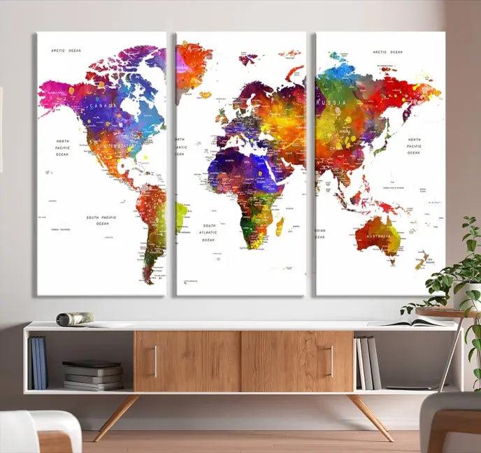 In this stylish living room, a vibrant Watercolor World Map Push Pin Poster Print, enhanced with a satin varnish for extra elegance, is displayed prominently.