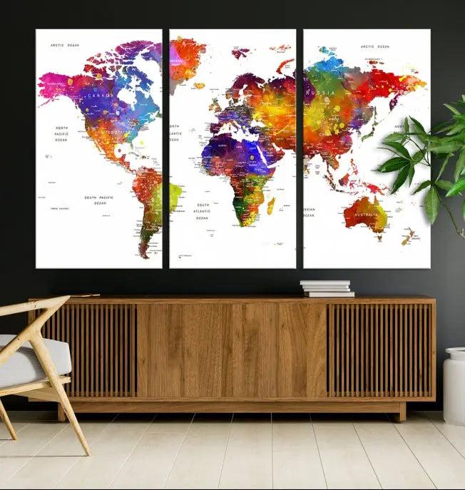 In this stylish living room, a vibrant Watercolor World Map Push Pin Poster Print, enhanced with a satin varnish for extra elegance, is displayed prominently.