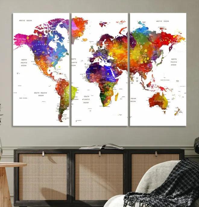 In this stylish living room, a vibrant Watercolor World Map Push Pin Poster Print, enhanced with a satin varnish for extra elegance, is displayed prominently.