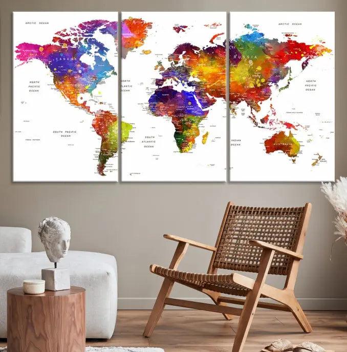 In this stylish living room, a vibrant Watercolor World Map Push Pin Poster Print, enhanced with a satin varnish for extra elegance, is displayed prominently.