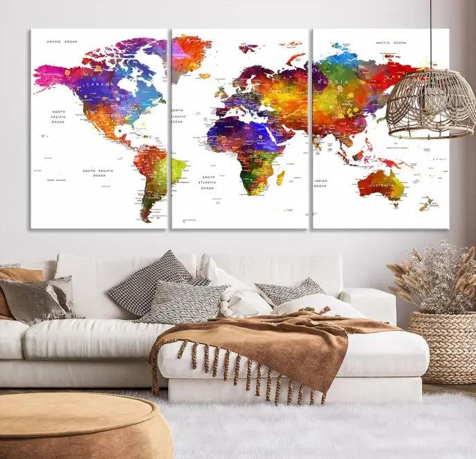 In this stylish living room, a vibrant Watercolor World Map Push Pin Poster Print, enhanced with a satin varnish for extra elegance, is displayed prominently.