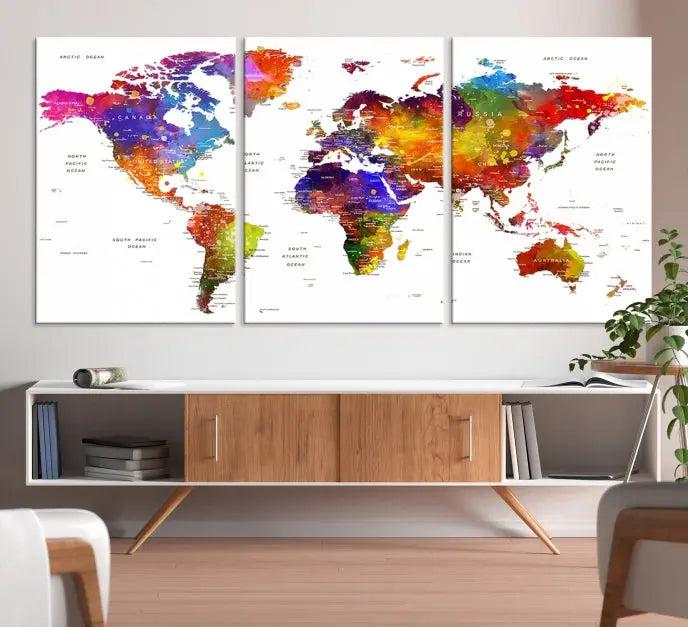 In this stylish living room, a vibrant Watercolor World Map Push Pin Poster Print, enhanced with a satin varnish for extra elegance, is displayed prominently.