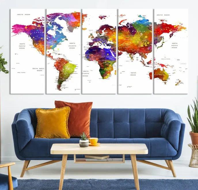 In this stylish living room, a vibrant Watercolor World Map Push Pin Poster Print, enhanced with a satin varnish for extra elegance, is displayed prominently.