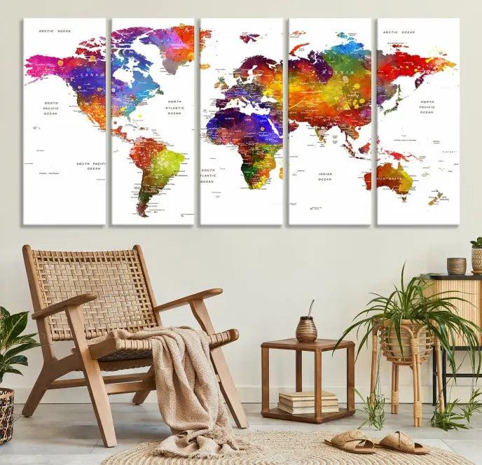 In this stylish living room, a vibrant Watercolor World Map Push Pin Poster Print, enhanced with a satin varnish for extra elegance, is displayed prominently.