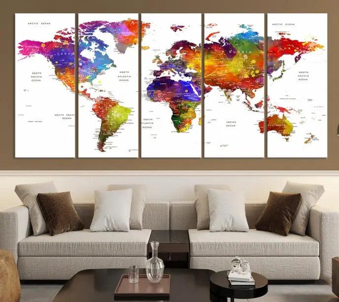 In this stylish living room, a vibrant Watercolor World Map Push Pin Poster Print, enhanced with a satin varnish for extra elegance, is displayed prominently.