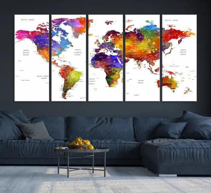 In this stylish living room, a vibrant Watercolor World Map Push Pin Poster Print, enhanced with a satin varnish for extra elegance, is displayed prominently.