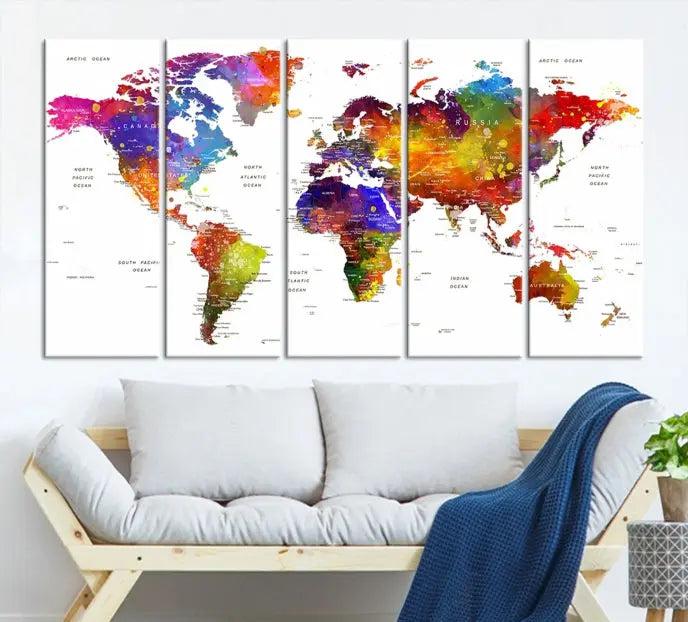 In this stylish living room, a vibrant Watercolor World Map Push Pin Poster Print, enhanced with a satin varnish for extra elegance, is displayed prominently.