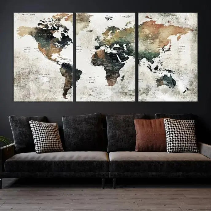 The dark wall is elegantly adorned with the Watercolor World Map Wall Art Canvas Print in a triptych style. Each canvas features a UV-protective coating and is ready to hang, seamlessly blending sophistication with practicality.