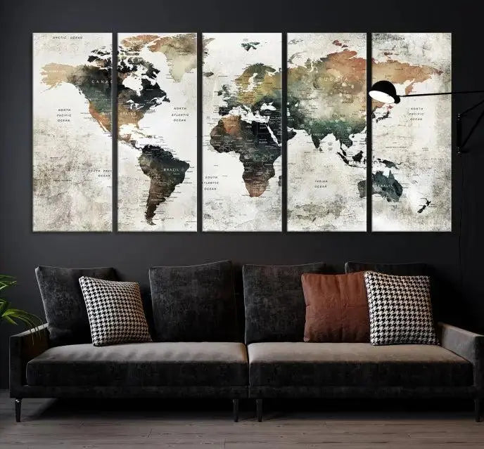 The dark wall is elegantly adorned with the Watercolor World Map Wall Art Canvas Print in a triptych style. Each canvas features a UV-protective coating and is ready to hang, seamlessly blending sophistication with practicality.