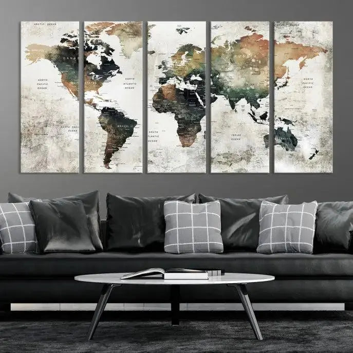 The dark wall is elegantly adorned with the Watercolor World Map Wall Art Canvas Print in a triptych style. Each canvas features a UV-protective coating and is ready to hang, seamlessly blending sophistication with practicality.