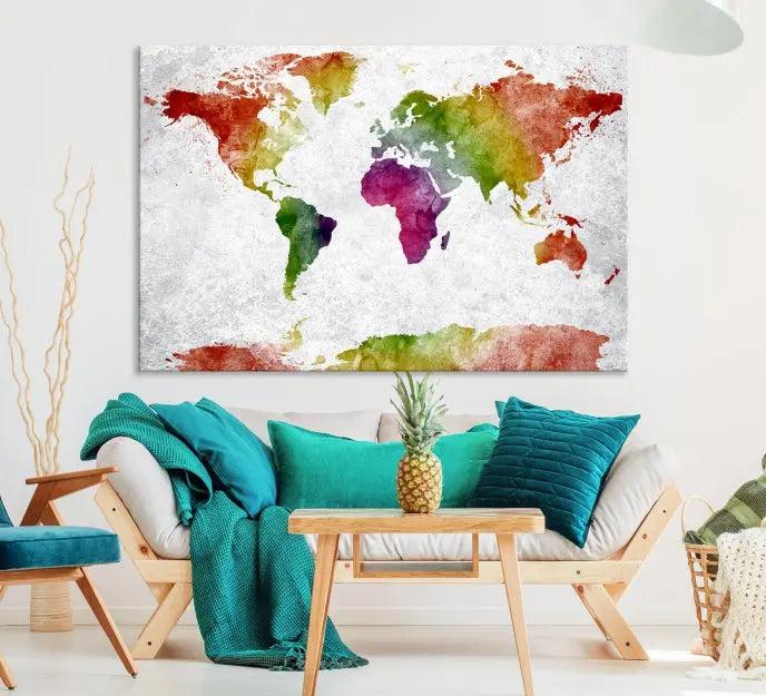 The Watercolor World Map Wall Art Canvas Print, a triptych printed on museum-quality canvases with UV-protective coating, hangs elegantly in a modern living room setting. Ready to hang, it adds an elegant touch to your space.