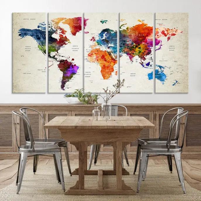 A Watercolor World Map Wall Art Canvas Print, spread across three panels, adorns a dark wall.