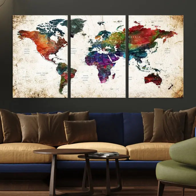 A three-panel Watercolor World Map Wall Art Canvas Print, crafted on museum-quality canvas with a UV-protective coating, is displayed against the dark wall. Ready to hang, it brings vibrant colors and sophistication to your space.