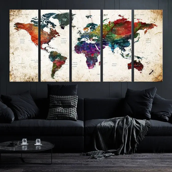 A three-panel Watercolor World Map Wall Art Canvas Print, crafted on museum-quality canvas with a UV-protective coating, is displayed against the dark wall. Ready to hang, it brings vibrant colors and sophistication to your space.