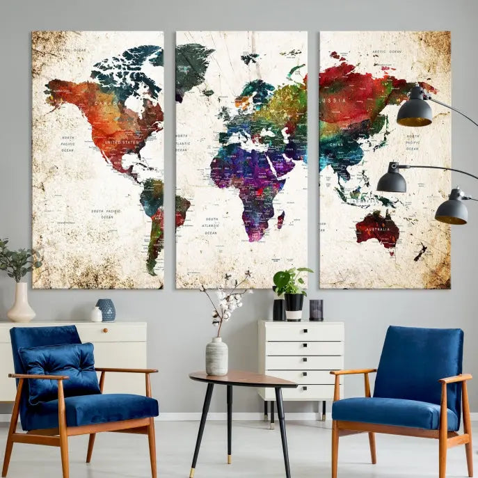 A three-panel Watercolor World Map Wall Art Canvas Print, crafted on museum-quality canvas with a UV-protective coating, is displayed against the dark wall. Ready to hang, it brings vibrant colors and sophistication to your space.