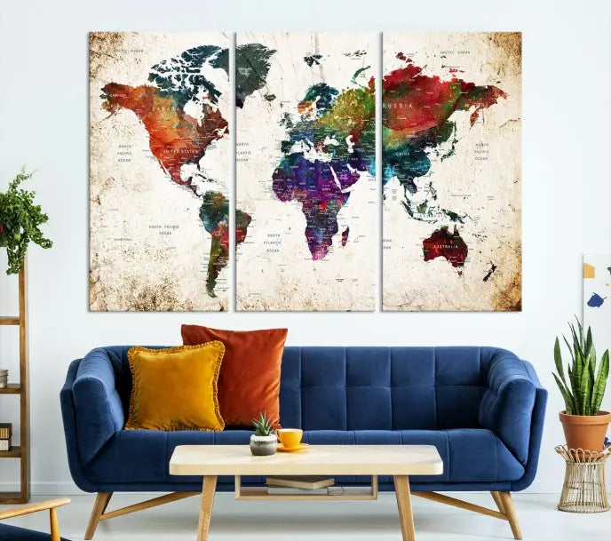 A three-panel Watercolor World Map Wall Art Canvas Print, crafted on museum-quality canvas with a UV-protective coating, is displayed against the dark wall. Ready to hang, it brings vibrant colors and sophistication to your space.