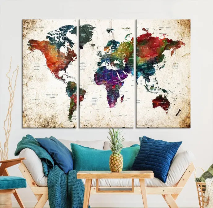 A three-panel Watercolor World Map Wall Art Canvas Print, crafted on museum-quality canvas with a UV-protective coating, is displayed against the dark wall. Ready to hang, it brings vibrant colors and sophistication to your space.