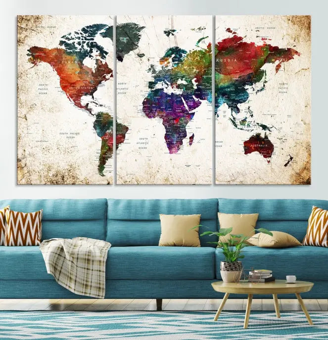 A three-panel Watercolor World Map Wall Art Canvas Print, crafted on museum-quality canvas with a UV-protective coating, is displayed against the dark wall. Ready to hang, it brings vibrant colors and sophistication to your space.