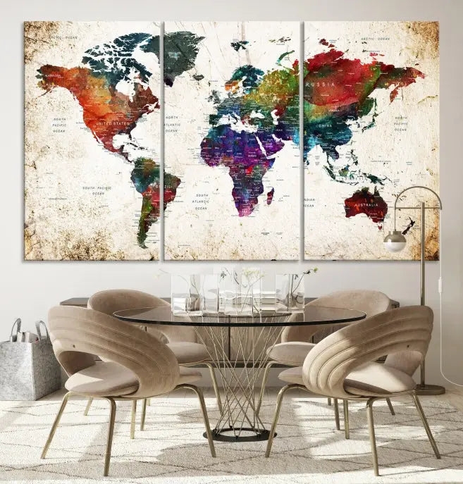 A three-panel Watercolor World Map Wall Art Canvas Print, crafted on museum-quality canvas with a UV-protective coating, is displayed against the dark wall. Ready to hang, it brings vibrant colors and sophistication to your space.