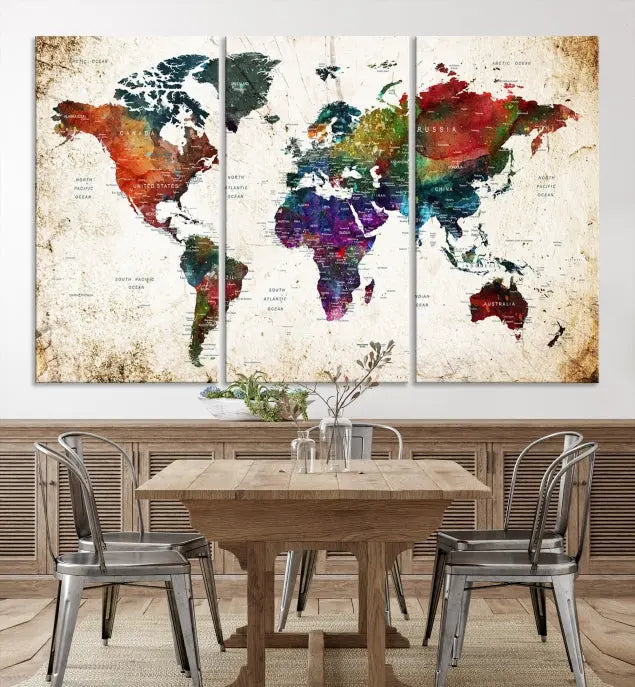 A three-panel Watercolor World Map Wall Art Canvas Print, crafted on museum-quality canvas with a UV-protective coating, is displayed against the dark wall. Ready to hang, it brings vibrant colors and sophistication to your space.