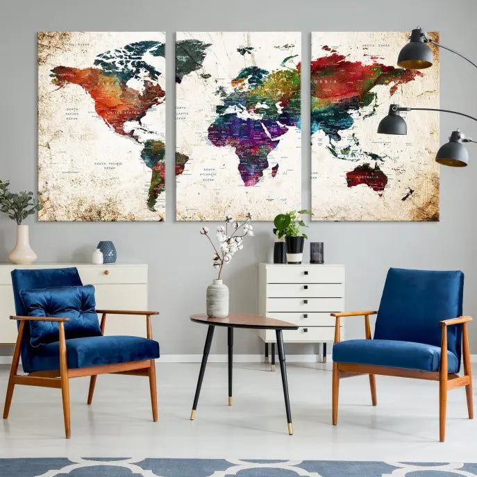 A three-panel Watercolor World Map Wall Art Canvas Print, crafted on museum-quality canvas with a UV-protective coating, is displayed against the dark wall. Ready to hang, it brings vibrant colors and sophistication to your space.