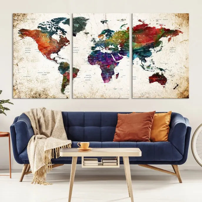 A three-panel Watercolor World Map Wall Art Canvas Print, crafted on museum-quality canvas with a UV-protective coating, is displayed against the dark wall. Ready to hang, it brings vibrant colors and sophistication to your space.