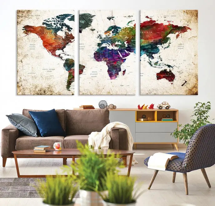 A three-panel Watercolor World Map Wall Art Canvas Print, crafted on museum-quality canvas with a UV-protective coating, is displayed against the dark wall. Ready to hang, it brings vibrant colors and sophistication to your space.