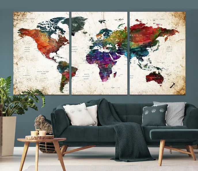 A three-panel Watercolor World Map Wall Art Canvas Print, crafted on museum-quality canvas with a UV-protective coating, is displayed against the dark wall. Ready to hang, it brings vibrant colors and sophistication to your space.