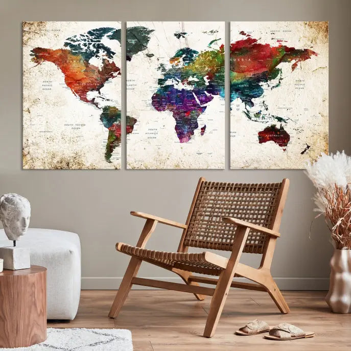 A three-panel Watercolor World Map Wall Art Canvas Print, crafted on museum-quality canvas with a UV-protective coating, is displayed against the dark wall. Ready to hang, it brings vibrant colors and sophistication to your space.