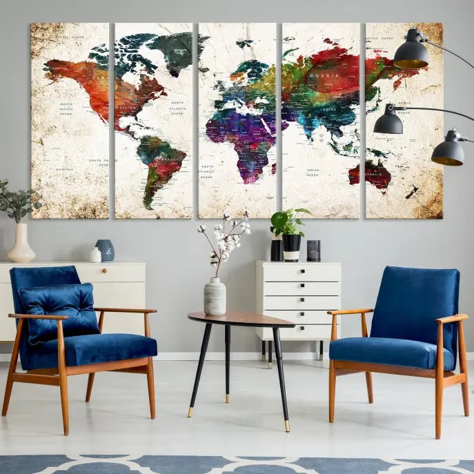 A three-panel Watercolor World Map Wall Art Canvas Print, crafted on museum-quality canvas with a UV-protective coating, is displayed against the dark wall. Ready to hang, it brings vibrant colors and sophistication to your space.