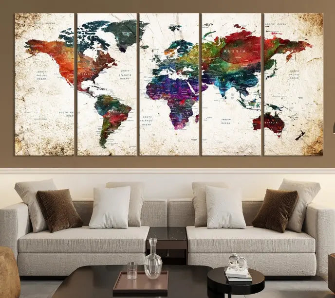 A three-panel Watercolor World Map Wall Art Canvas Print, crafted on museum-quality canvas with a UV-protective coating, is displayed against the dark wall. Ready to hang, it brings vibrant colors and sophistication to your space.