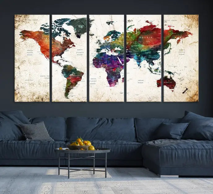 A three-panel Watercolor World Map Wall Art Canvas Print, crafted on museum-quality canvas with a UV-protective coating, is displayed against the dark wall. Ready to hang, it brings vibrant colors and sophistication to your space.