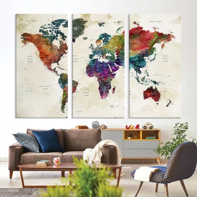 The room showcases the Watercolor World Map Wall Art Canvas Print, professionally framed on museum-quality pollycotton canvas.