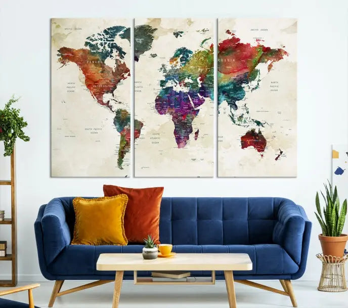 The room showcases the Watercolor World Map Wall Art Canvas Print, professionally framed on museum-quality pollycotton canvas.