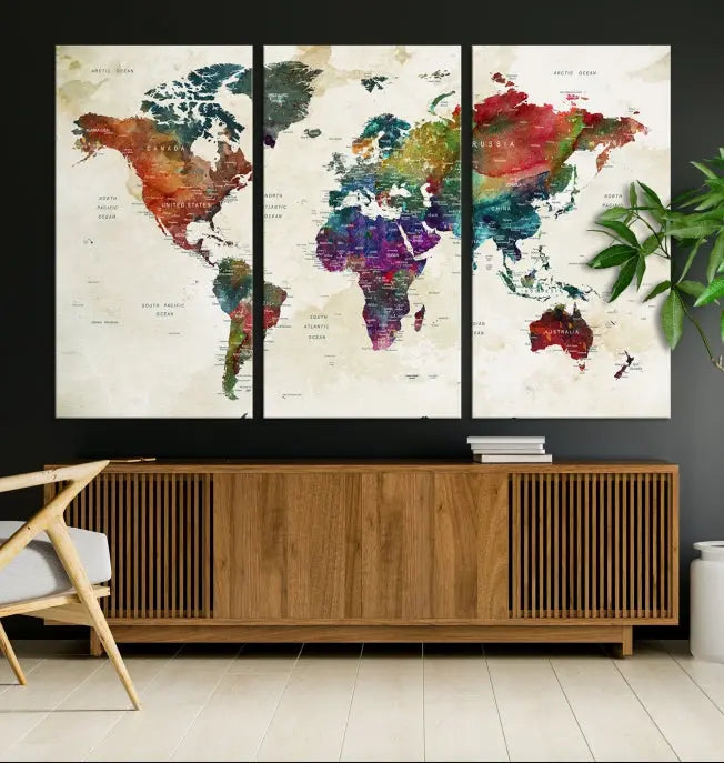 The room showcases the Watercolor World Map Wall Art Canvas Print, professionally framed on museum-quality pollycotton canvas.