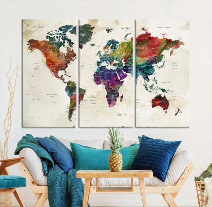 The room showcases the Watercolor World Map Wall Art Canvas Print, professionally framed on museum-quality pollycotton canvas.