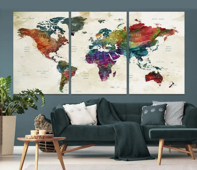 The room showcases the Watercolor World Map Wall Art Canvas Print, professionally framed on museum-quality pollycotton canvas.