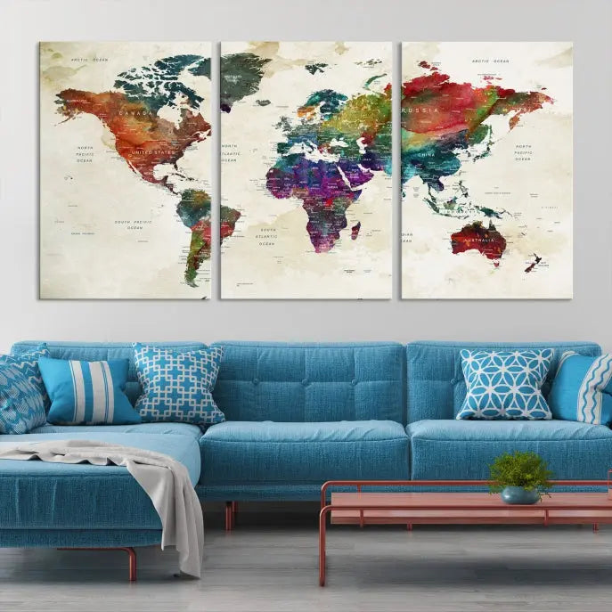 The room showcases the Watercolor World Map Wall Art Canvas Print, professionally framed on museum-quality pollycotton canvas.