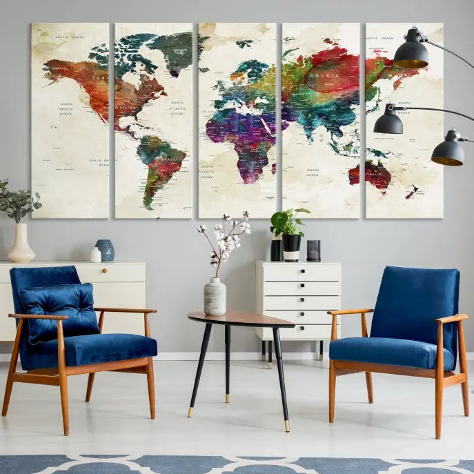 The room showcases the Watercolor World Map Wall Art Canvas Print, professionally framed on museum-quality pollycotton canvas.