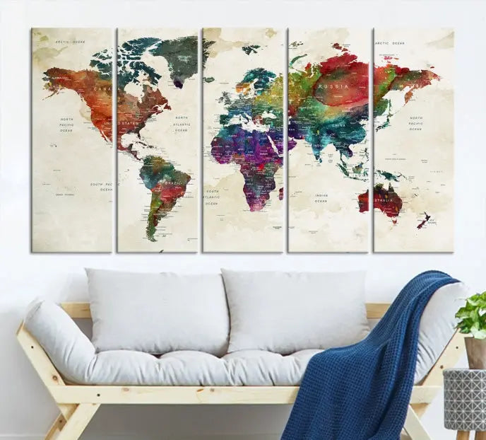 The room showcases the Watercolor World Map Wall Art Canvas Print, professionally framed on museum-quality pollycotton canvas.