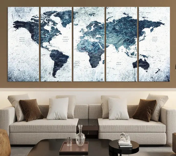 The "Watercolor World Map Wall Art Canvas Print," treated with a UV-protective coating to maintain its vivid colors, is displayed in a modern living room.