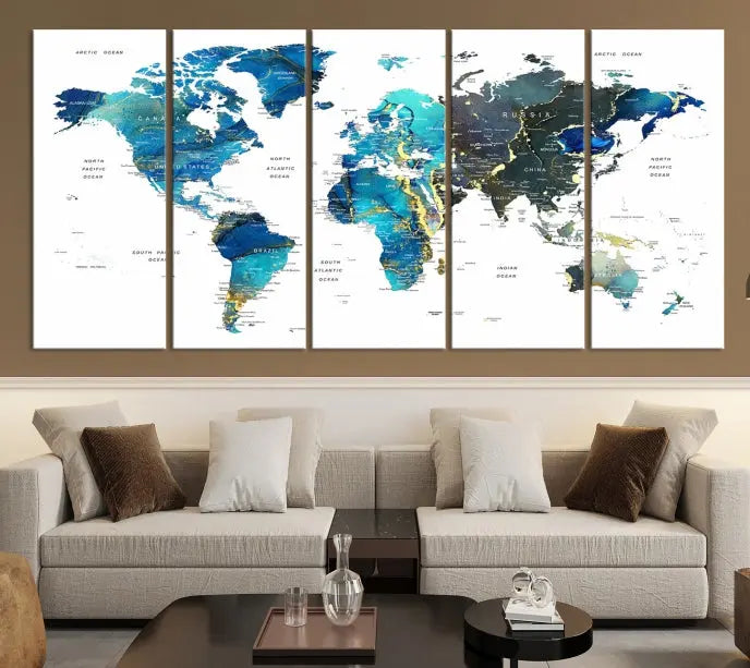 A hand-assembled, three-panel Watercolor World Map Wall Art Canvas Print in shades of blue and green adds a ready-to-hang touch of elegance to the living room.