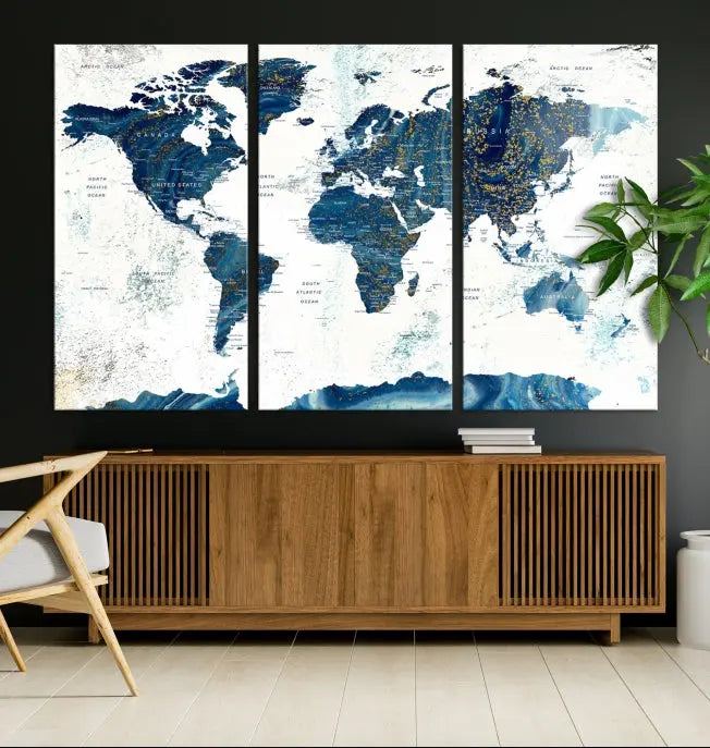 Hanging above is the Watercolor World Map Wall Art Canvas Print, displayed in blue and white tones on museum-quality canvas with a gallery wrap.