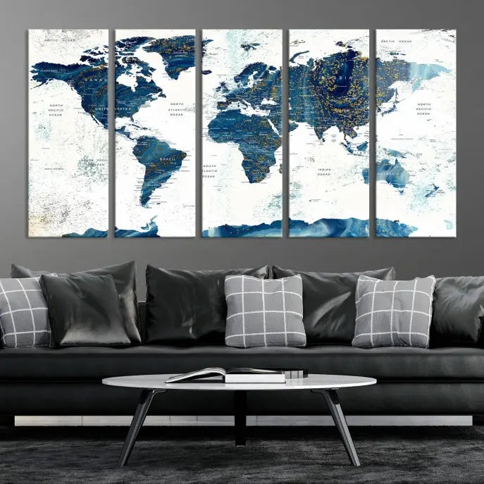 Hanging above is the Watercolor World Map Wall Art Canvas Print, displayed in blue and white tones on museum-quality canvas with a gallery wrap.