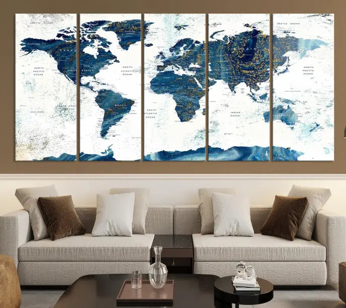 Hanging above is the Watercolor World Map Wall Art Canvas Print, displayed in blue and white tones on museum-quality canvas with a gallery wrap.